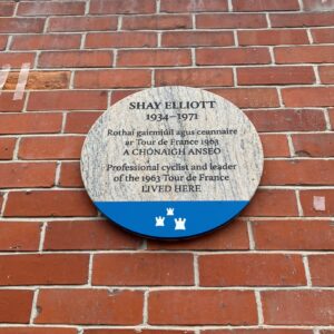Photograph of commemorative plaque on brick wall.
